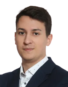 Modrá minimalistická ikona domečku s lupou, skrze lupu je vidět symbol dolaru.
