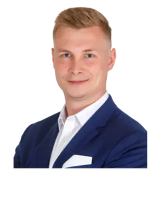 Modrá minimalistická ikona domečku s lupou, skrze lupu je vidět symbol dolaru.